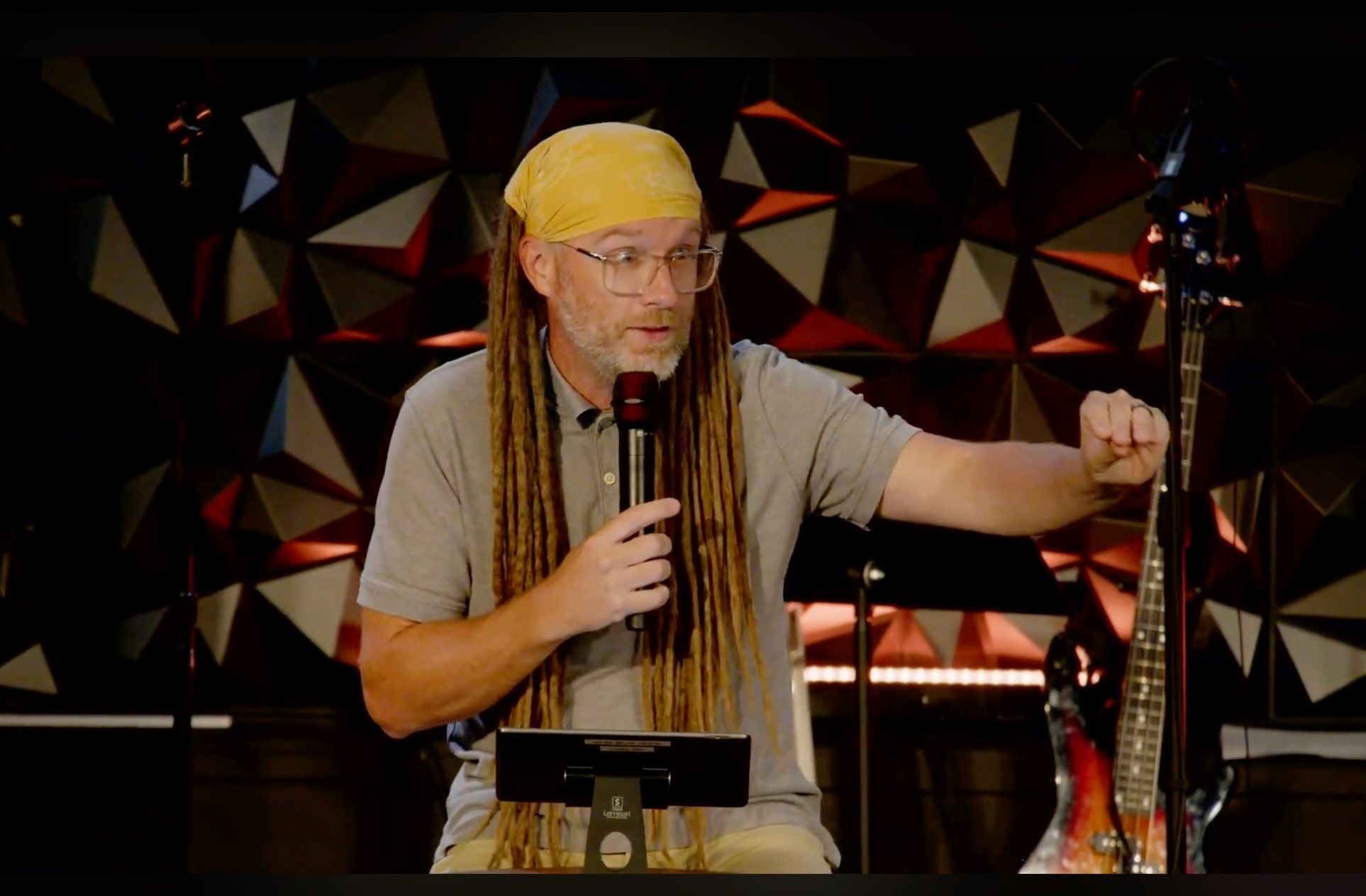 Pastor preaching from the Grace Church stage on a Sunday